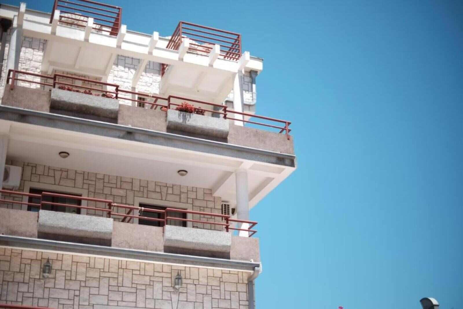 Balconies of H Kleopatra hotel against a blue sky in Ulcinj